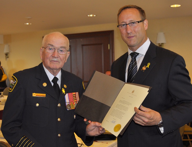 Harold A. Conrad receive his award from the Hon. Peter McKay